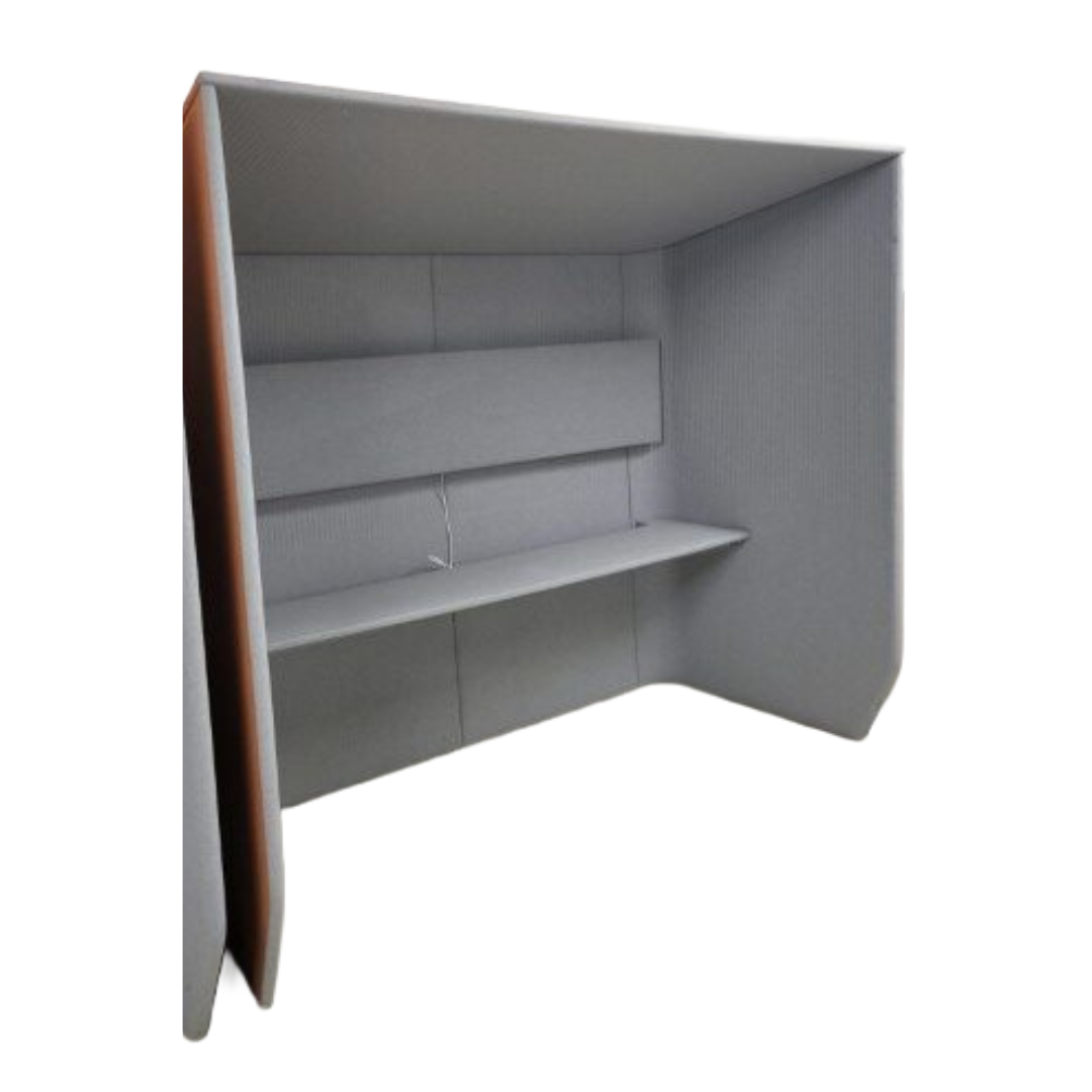 Gray soundproof office pod with three walls and a built-in shelf. The design is modern and minimalist, offering privacy and a quiet workspace.