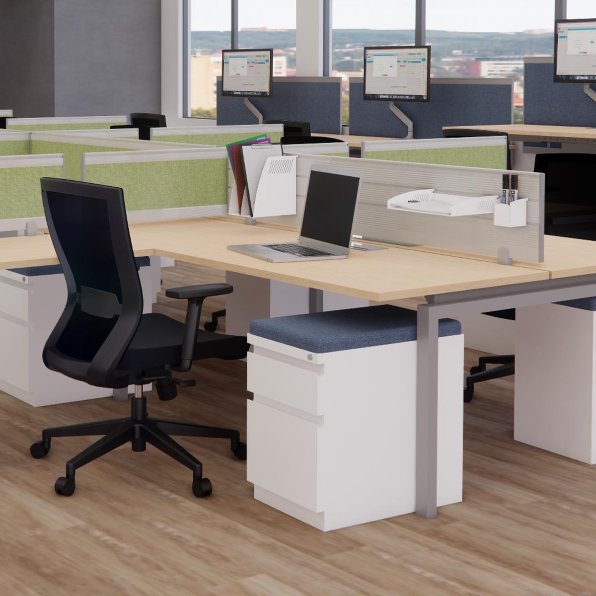 Modern open-plan office with rows of desks, black swivel chairs, and computer monitors. Large windows provide natural light, creating a bright ambiance.