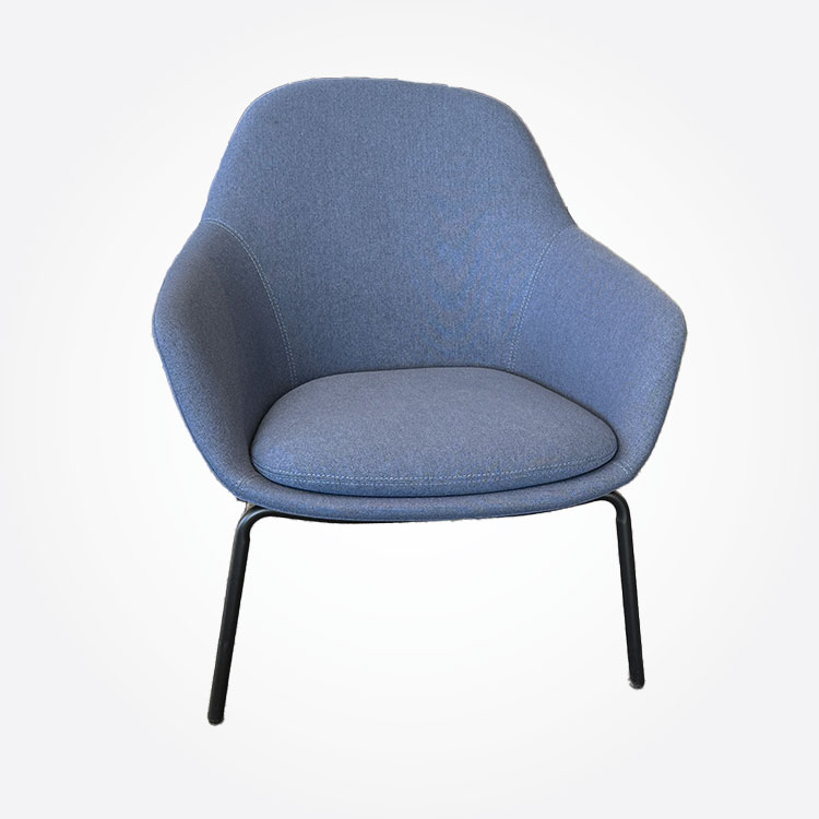 Dark blue, modern, upholstered chair with curved backrest and seat, supported by a four-legged metal base, against a plain white background.