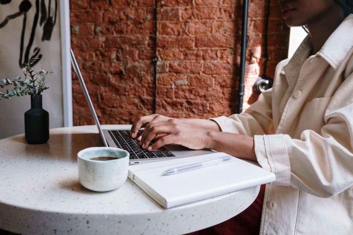 Person writing a blog in a cafe.