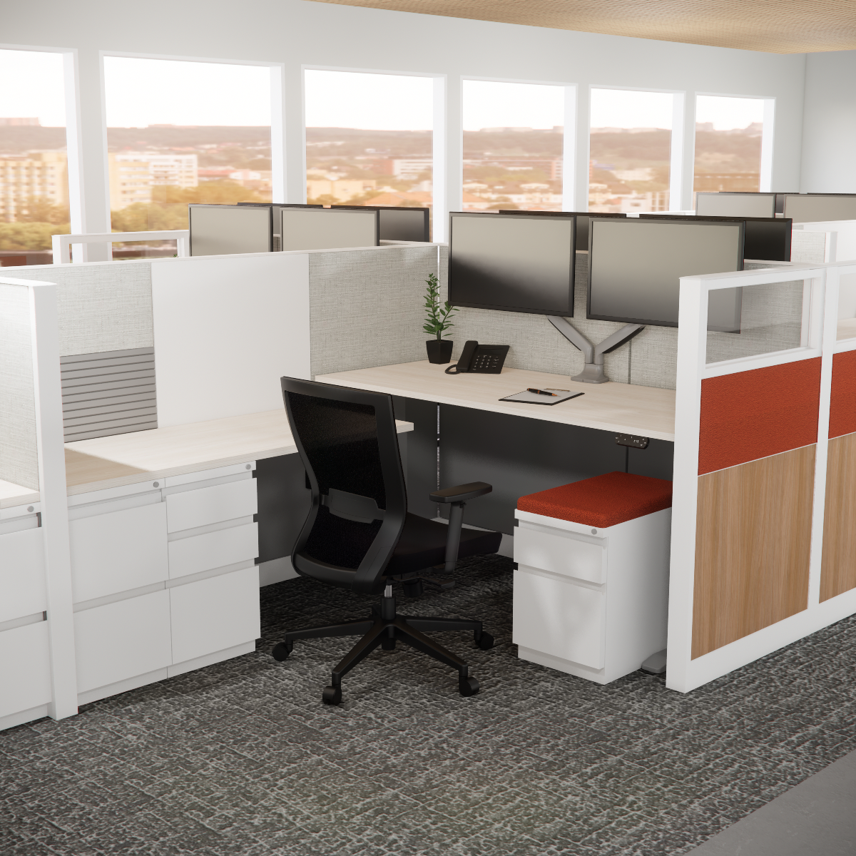 A modern office cubicle with a sleek black chair, dual monitors, a phone, and a notepad. Bright windowed backdrop, calm and organized atmosphere.