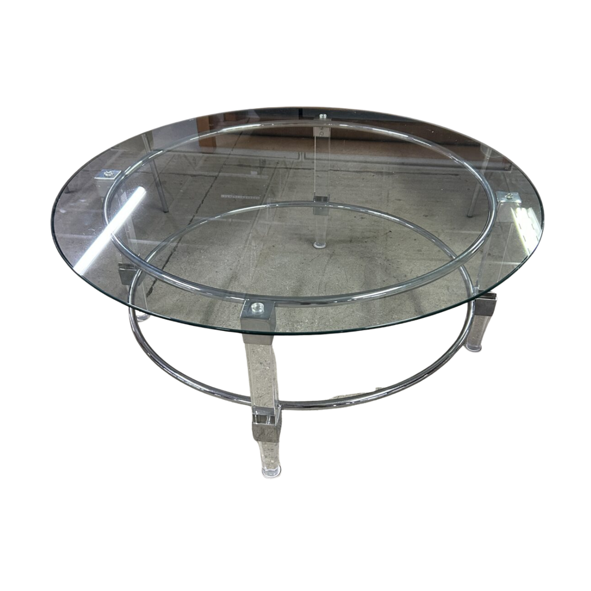 Round glass coffee table with a sleek metal frame and legs. The design is modern and minimalist, projecting a contemporary and stylish look.