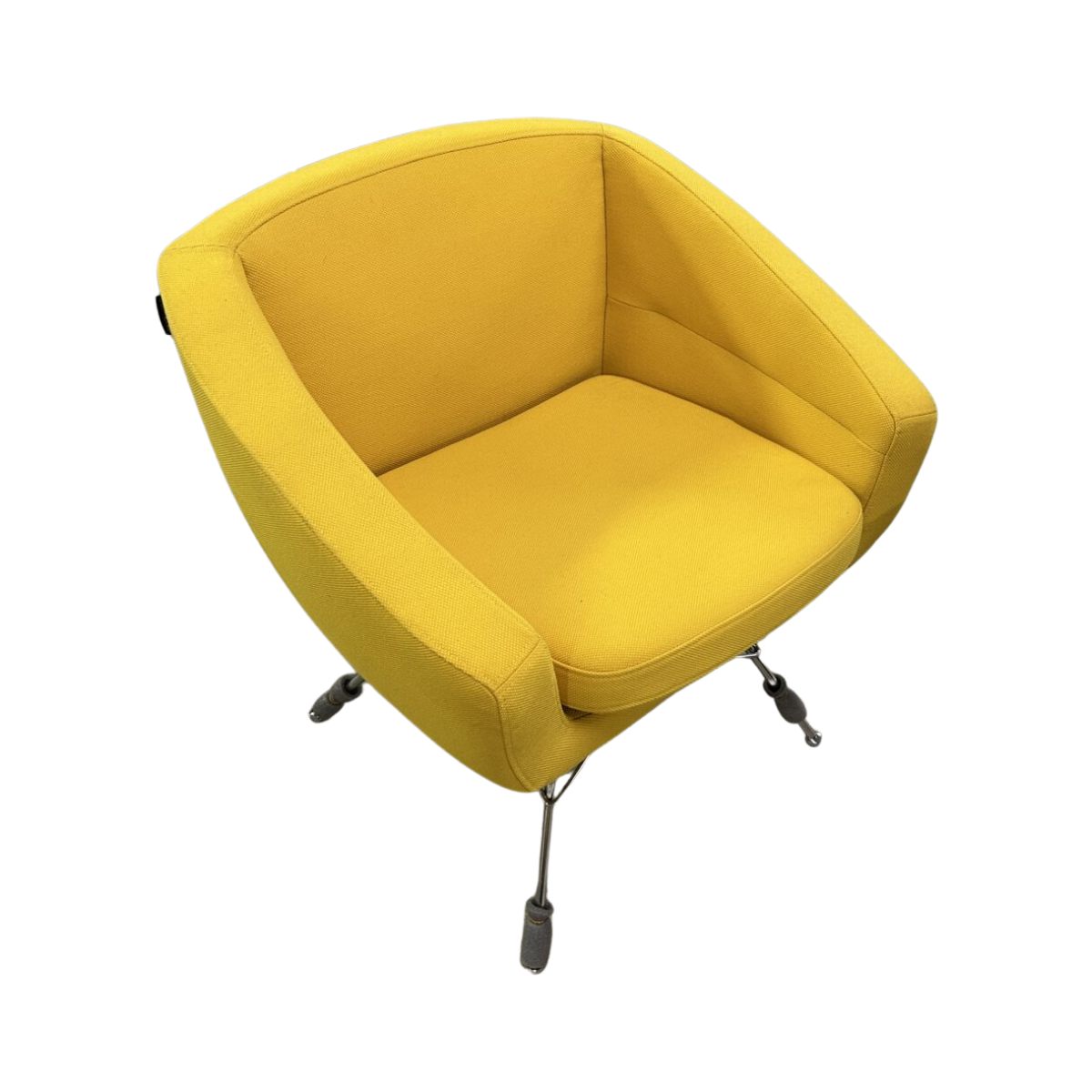 Modern yellow armchair with curved back and seat cushion, featuring metal legs with small wheels. It has a sleek, contemporary design.