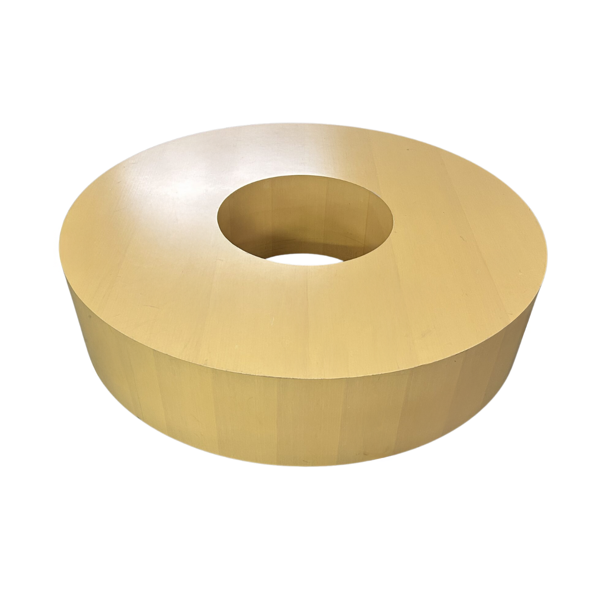 A wooden, donut-shaped coffee table with a smooth, light tan surface and an open center, creating a modern and minimalist design aesthetic.