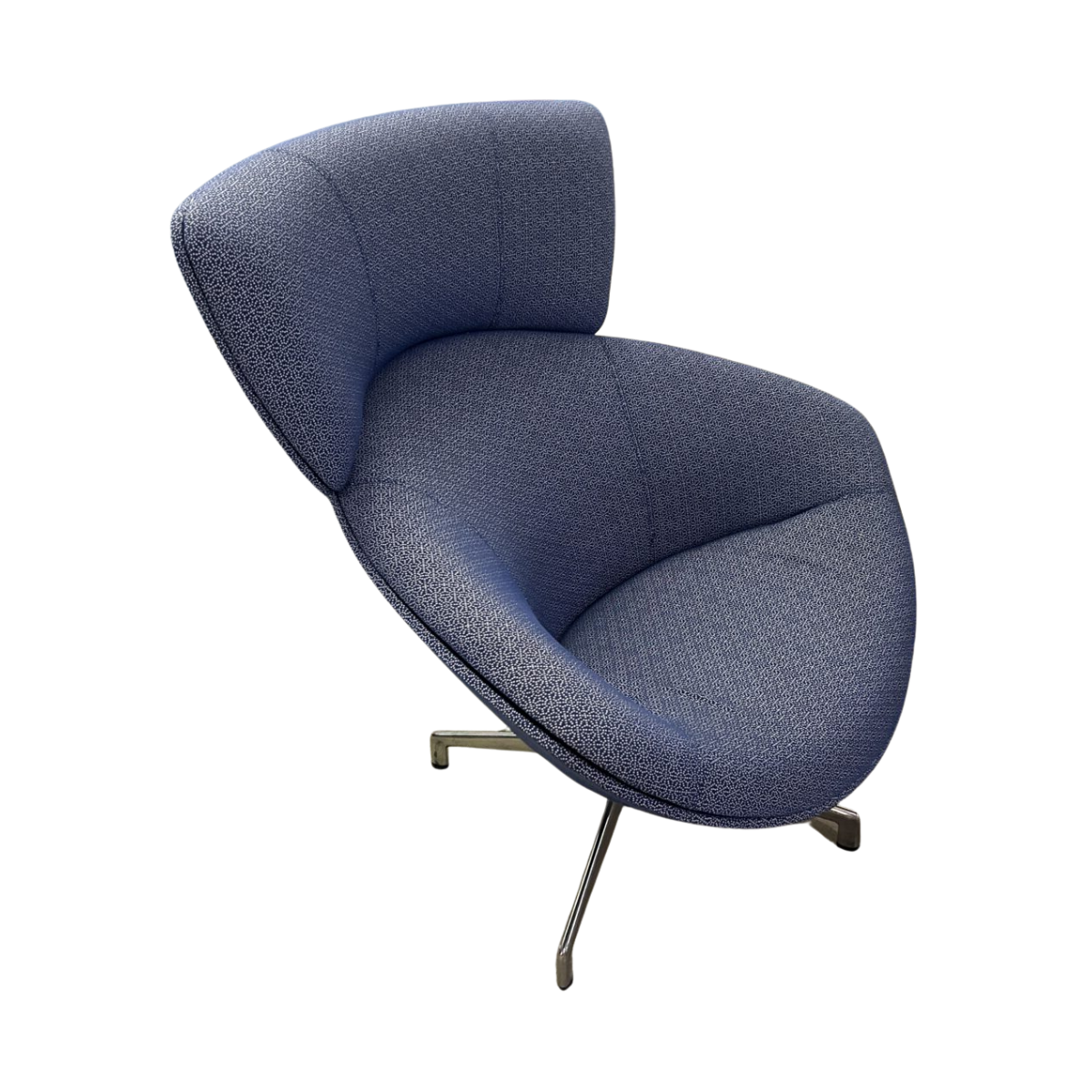 Modern blue lounge chair with a curved backrest and chrome legs, exuding a sleek and contemporary feel. The fabric texture adds elegance.